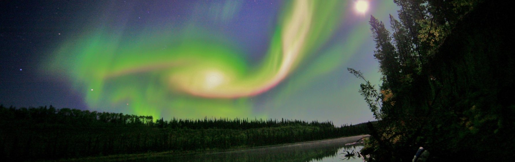 Aurora Over Whitehorse, Yukon. On August 31, 2012 a long filament of solar material that had been hovering in the sun's atmosphere, the corona, erupted out into space at 4:36 p.m. EDT. The coronal mass ejection, or CME, traveled at over 900 miles per second. The CME did not travel directly toward Earth, but did connect with Earth's magnetic environment, or magnetosphere, causing aurora to appear on the night of Monday, September 3. Swirls of green and red appear in an aurora over Whitehorse, Yukon on the night of September 3, 2012. The aurora was due to a coronal mass ejection from the sun, which erupted on August 31. Credit: Courtesy of David Cartier, Sr. Aurora Over Whitehorse, Yukon