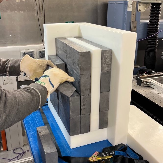 Polyethylene blocks and lead bricks being assembled.
